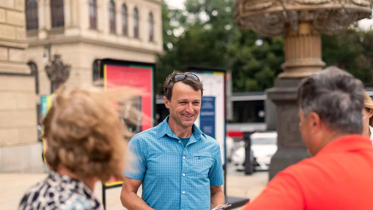 Guide with a small group on a cobbled Josefov street on a Prague Old Town and Jewish Quarter tour